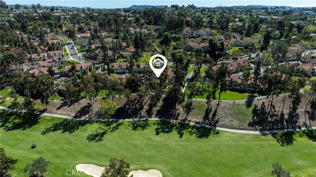 birds eye view of property with golf course view and a residential view