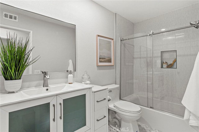 full bathroom with vanity, toilet, visible vents, and shower / bath combination with glass door