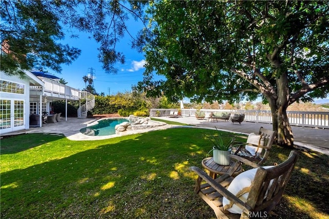 view of yard with a fenced in pool, fence, stairs, french doors, and a patio area