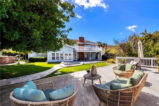 wooden deck with a lawn, french doors, and an outdoor hangout area