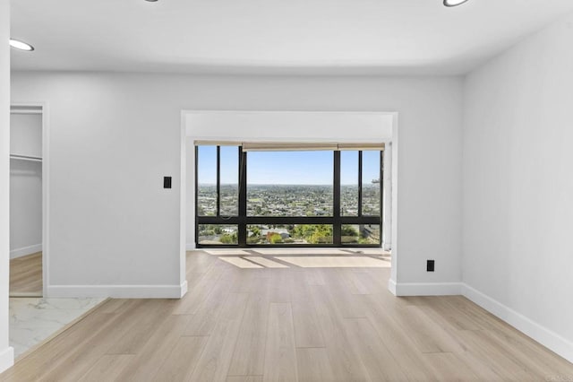 interior space featuring recessed lighting, wood finished floors, and baseboards