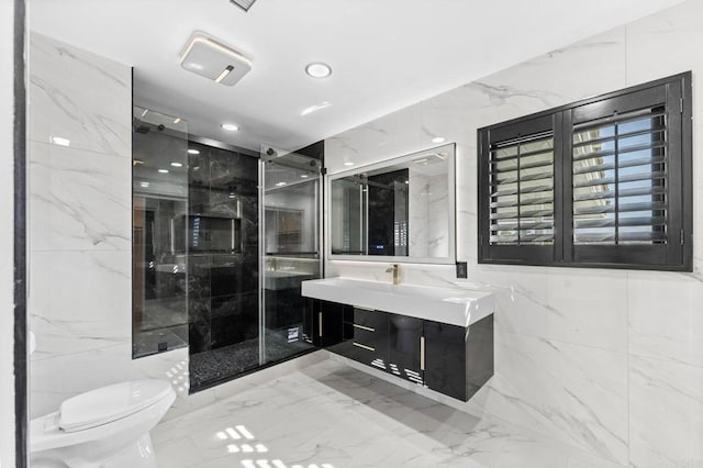 full bathroom with toilet, marble finish floor, a marble finish shower, tile walls, and vanity