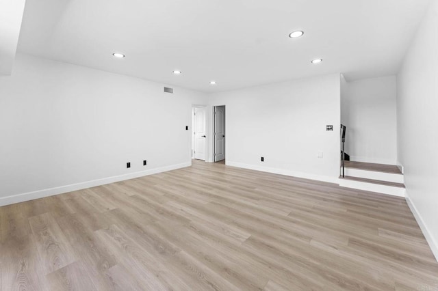 empty room with recessed lighting, light wood-type flooring, baseboards, and visible vents