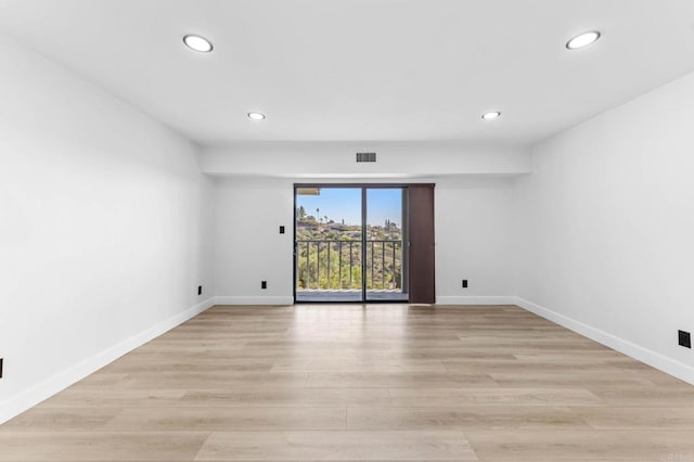 unfurnished room with visible vents, recessed lighting, light wood-style floors, and baseboards