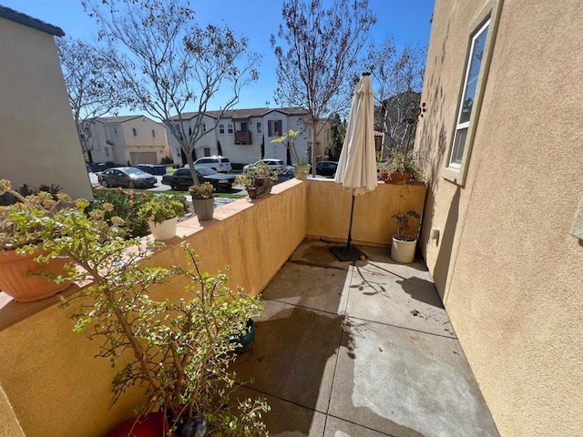 view of patio with a balcony and a residential view