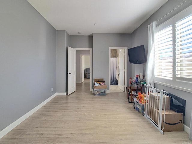 bedroom with baseboards and light wood-type flooring