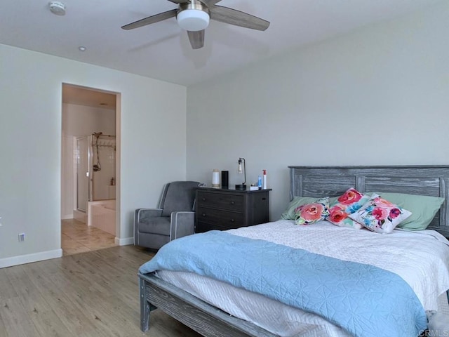 bedroom featuring connected bathroom, baseboards, wood finished floors, and a ceiling fan