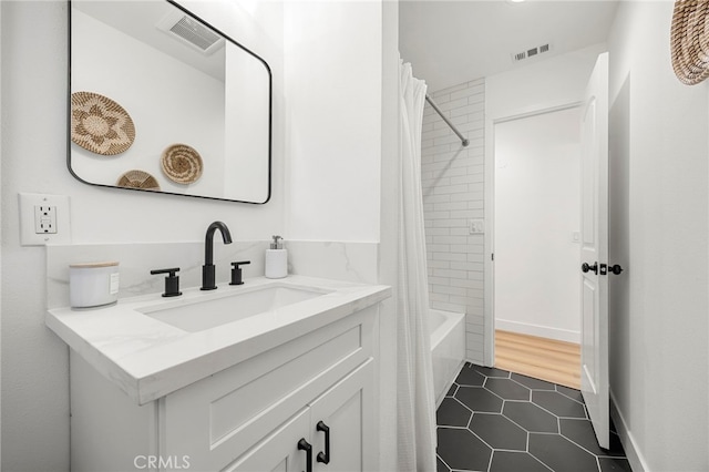 bathroom with vanity, tile patterned floors, visible vents, and shower / tub combo with curtain