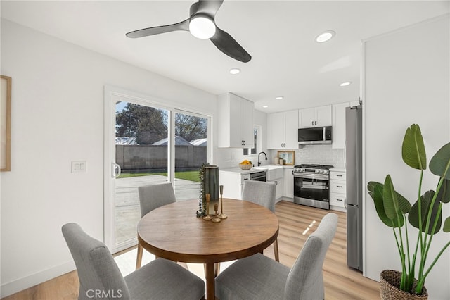 dining space with recessed lighting, baseboards, ceiling fan, and light wood finished floors