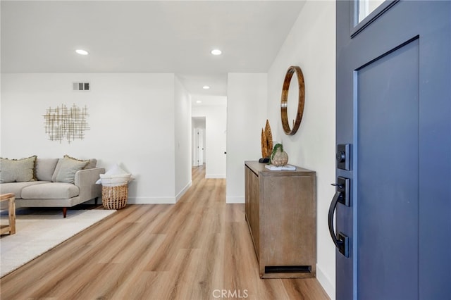 foyer featuring visible vents, recessed lighting, light wood-type flooring, and baseboards