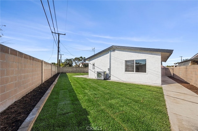 view of yard with ac unit and a fenced backyard