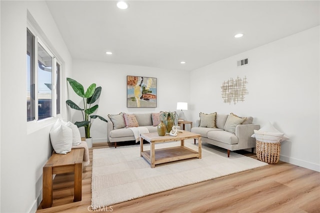 living room with visible vents, recessed lighting, wood finished floors, and baseboards