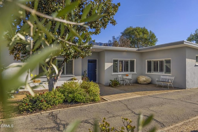 single story home with stucco siding and a patio