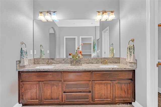 bathroom featuring double vanity and a sink