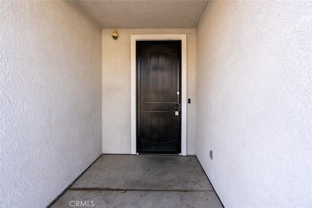 property entrance with stucco siding