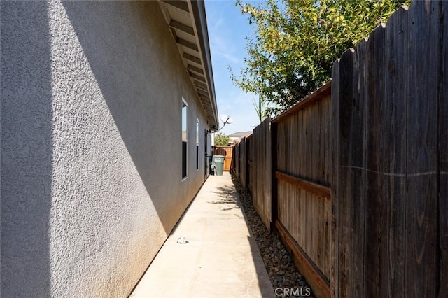 view of property exterior with a fenced backyard and stucco siding