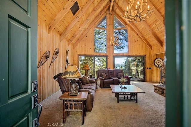 living room with high vaulted ceiling, beam ceiling, wood walls, carpet flooring, and a notable chandelier