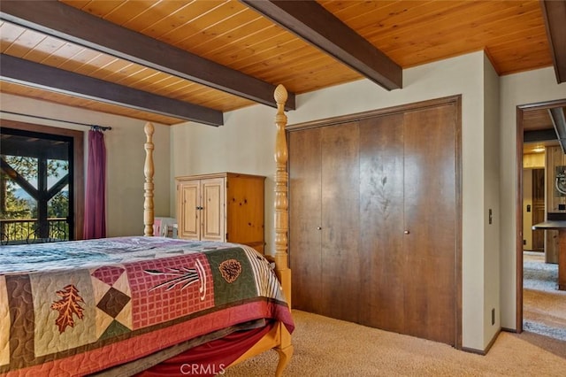 bedroom with beam ceiling, wooden ceiling, and carpet