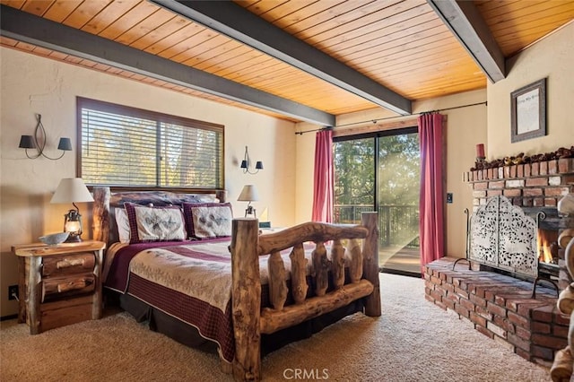 bedroom with wood ceiling, carpet floors, beam ceiling, a fireplace, and access to outside