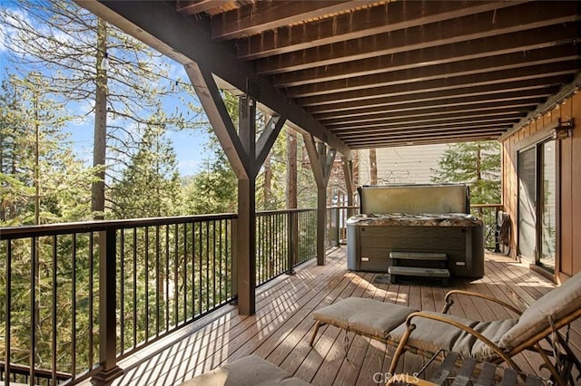 wooden deck with a hot tub