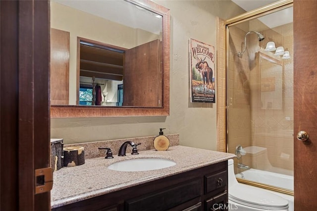 full bathroom with vanity, toilet, and combined bath / shower with glass door