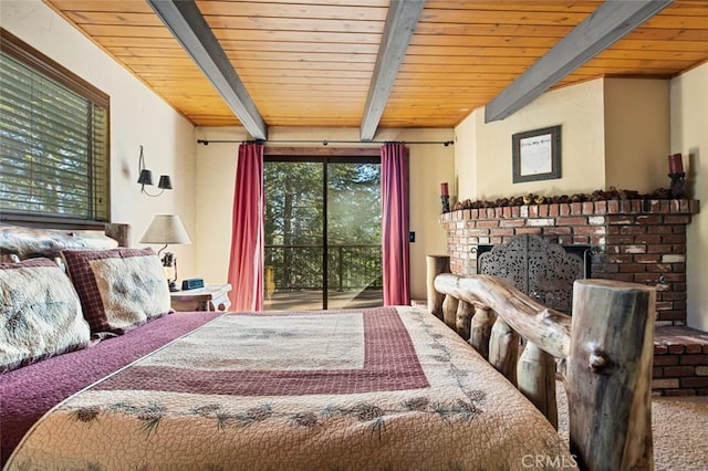 bedroom featuring access to exterior, a brick fireplace, beamed ceiling, carpet floors, and wooden ceiling