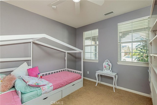 bedroom featuring visible vents, baseboards, carpet floors, and ceiling fan