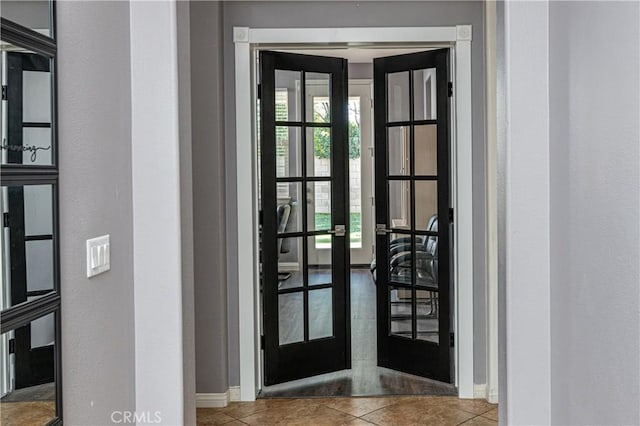 interior space with tile patterned floors, french doors, and baseboards