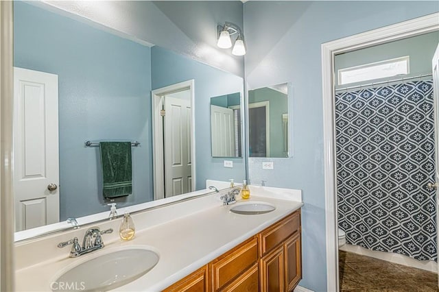 full bath with double vanity, a shower with shower curtain, and a sink