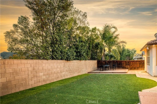 view of yard with outdoor dining area and fence