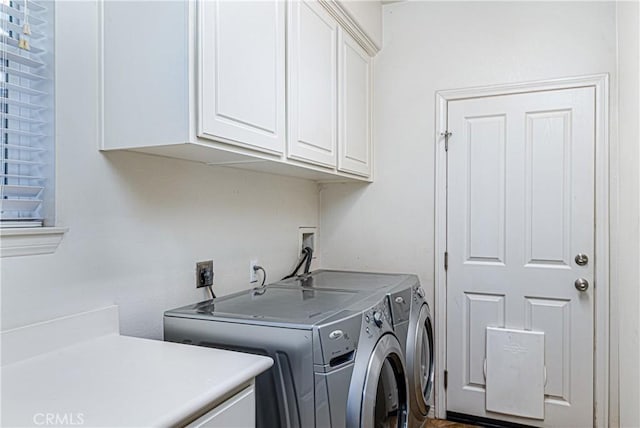 laundry room with cabinet space and separate washer and dryer