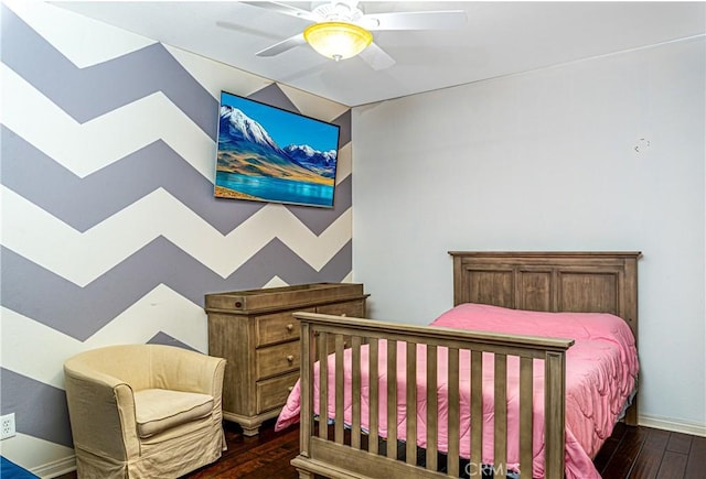 bedroom featuring dark wood finished floors, a ceiling fan, baseboards, and vaulted ceiling