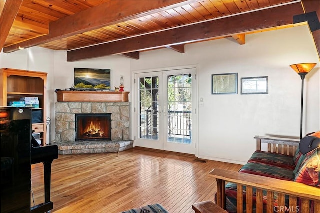 living area featuring beam ceiling, french doors, wood ceiling, and wood-type flooring