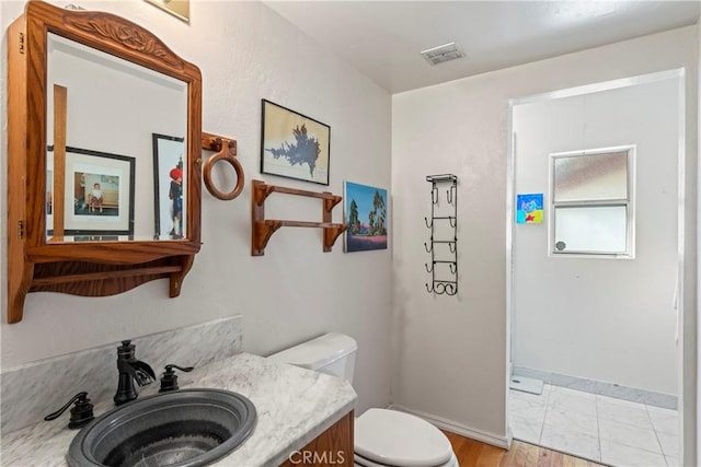 26509 Lake Forest Dr, Twin Peaks, CA 92391 - bathroom with wood finished floors, toilet, vanity, baseboards, and visible vents