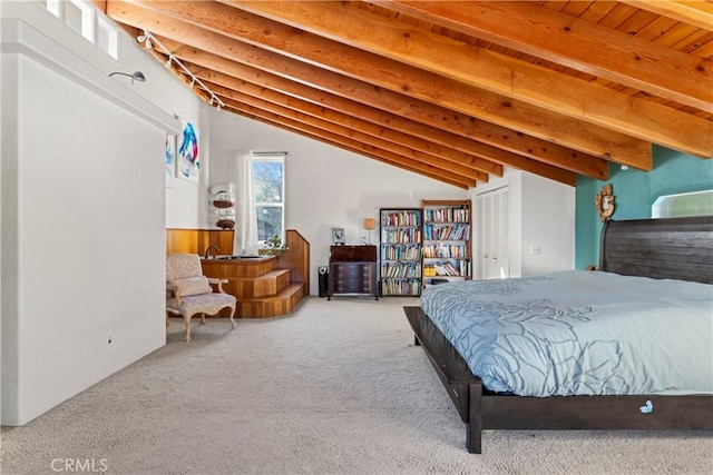 carpeted bedroom with beam ceiling