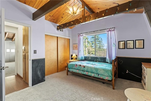 bedroom with a closet, carpet flooring, wooden ceiling, and lofted ceiling with beams