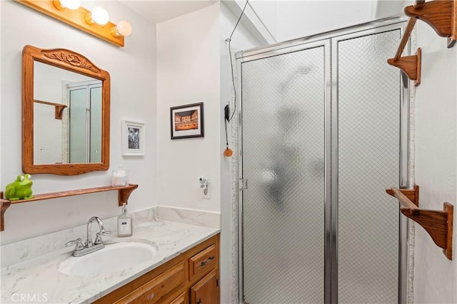 full bath featuring vanity and a shower stall