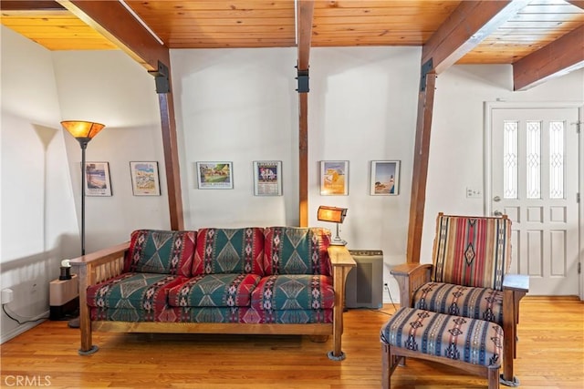 living room featuring beamed ceiling, wood finished floors, and wooden ceiling