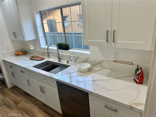 kitchen featuring a sink, light stone counters, white cabinets, dishwasher, and dark wood-style flooring