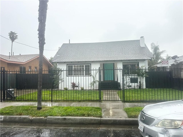 bungalow-style home featuring a fenced front yard, stucco siding, a front yard, and a gate