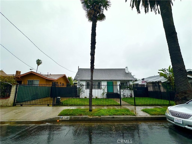 view of front facade with a fenced front yard and a front yard