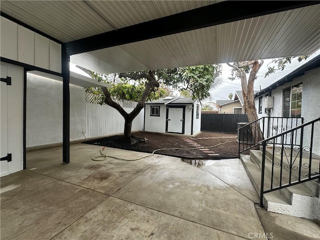 view of patio / terrace with a fenced backyard, a shed, and an outdoor structure