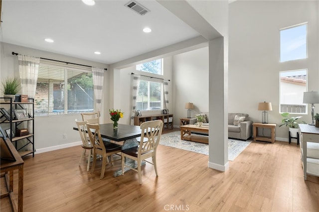 dining area featuring visible vents, baseboards, and light wood finished floors