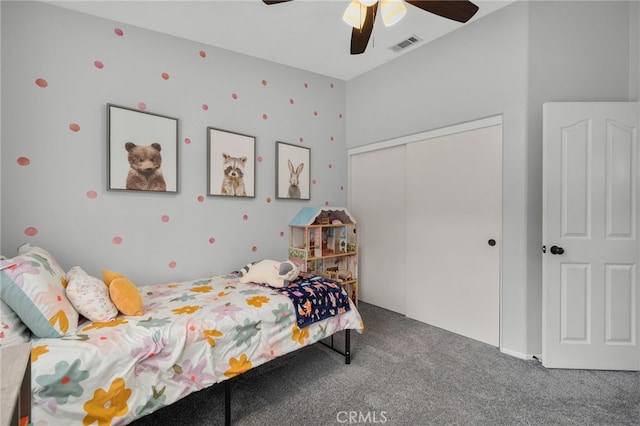 carpeted bedroom featuring a closet, visible vents, and ceiling fan