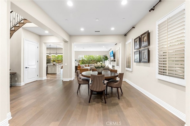 dining space featuring visible vents, recessed lighting, wood finished floors, and baseboards