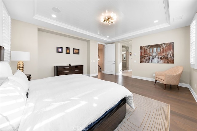 bedroom with a tray ceiling, baseboards, and dark wood-style flooring