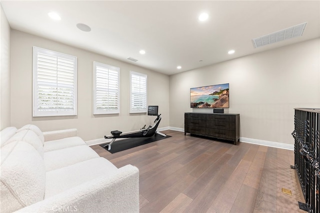 exercise area featuring recessed lighting, visible vents, and wood finished floors