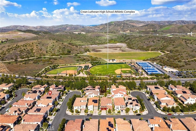 birds eye view of property with a mountain view and a residential view