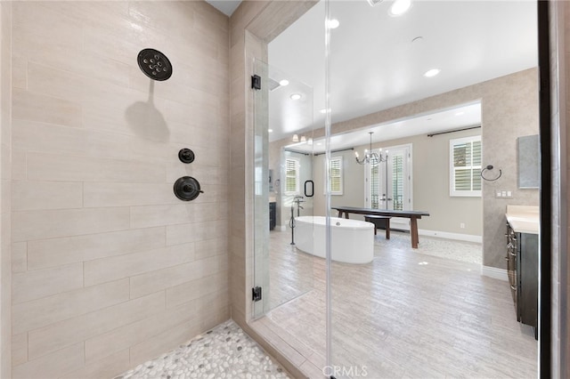 full bath featuring recessed lighting, a shower stall, baseboards, a freestanding bath, and vanity