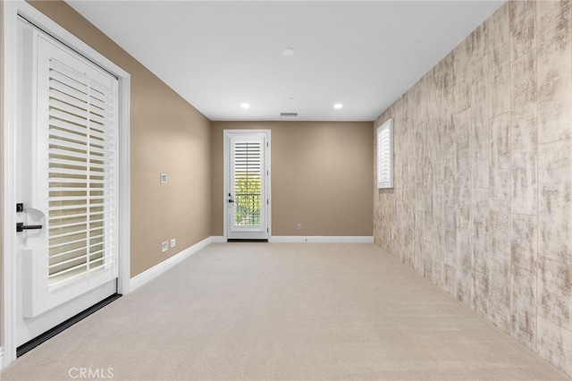 unfurnished room with visible vents, recessed lighting, carpet, and baseboards